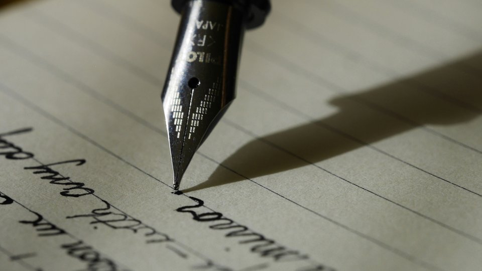 Close up of a fountain pen writing on paper