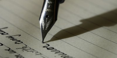 Close up of a fountain pen writing on paper