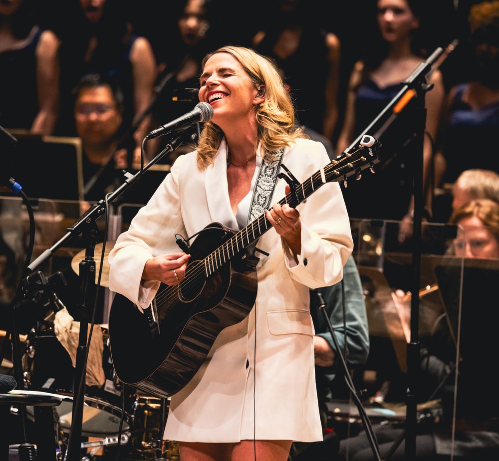 Aoife O'Donovan playing the guitar and singing