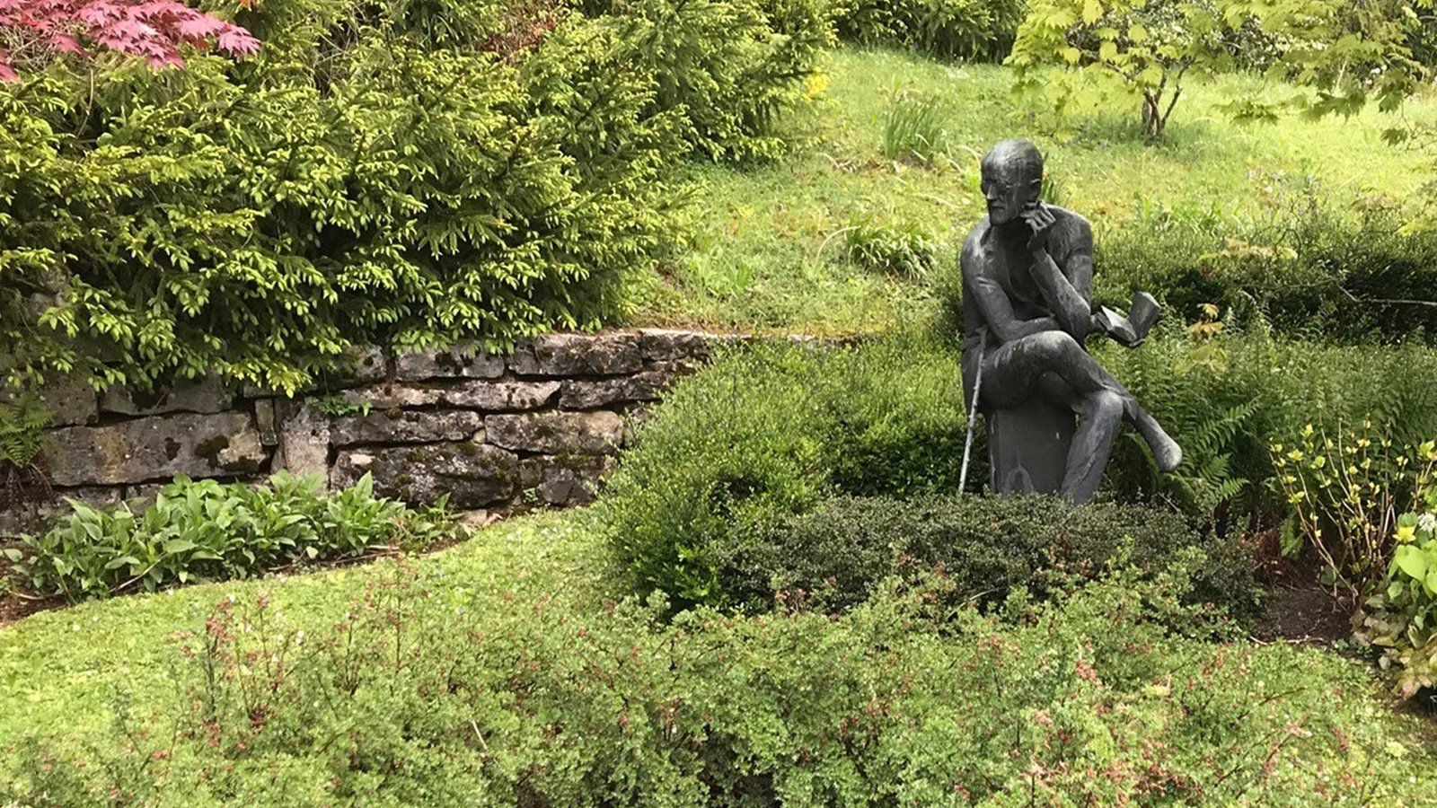 A statue of James Joyce in a garden.