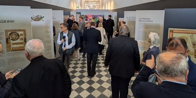 People looking at exhibition panels spaced along a corridor