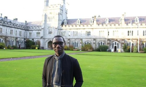man standing in front of a college