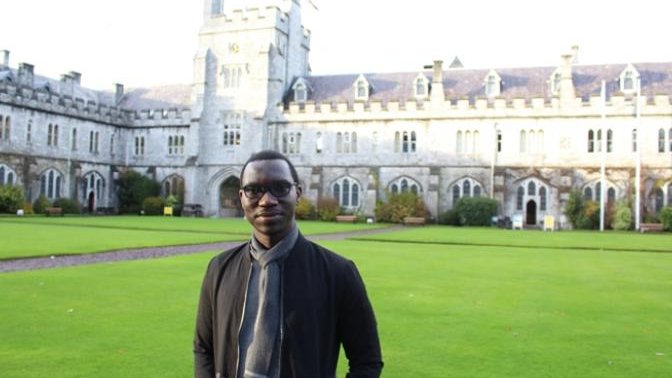 man standing in front of a college
