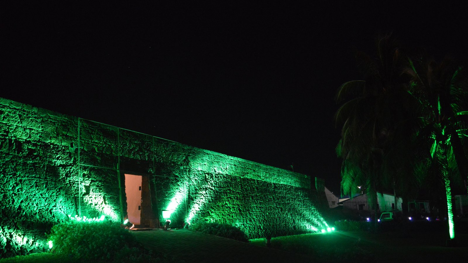 building lit up in green by night in Mozambique