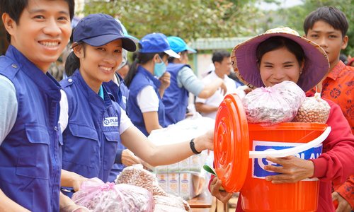Ms Cang, a farmer in Huc commune in Quang Tri province receives an emergency package from Plan International in Vietnam, funded by the Government of Ireland, in the immediate aftermath of severe flooding which caused devastation across Central Vietnam in October 2020 after six successive tropical storms.
