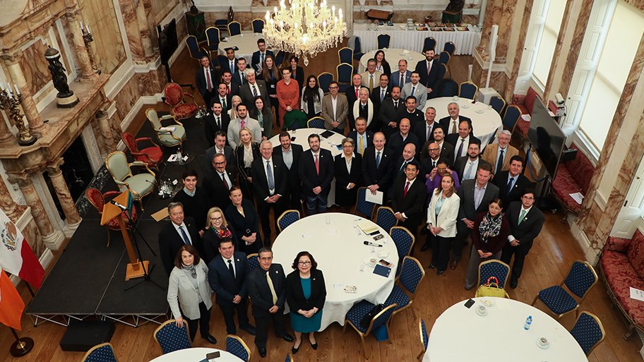 group shot in ornate dining room looking up