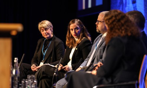 A panel speaking on a stage