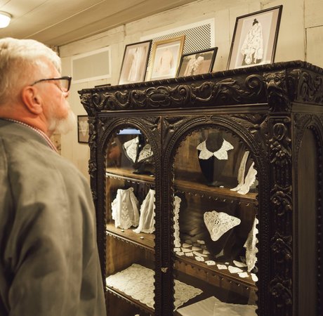 Close up of students' hands cutting up tweed for their projects