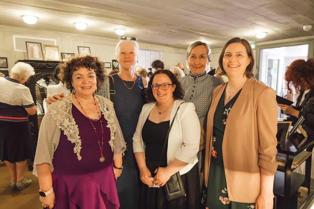 A group of people at an exhibition of Irish lace in Latvia