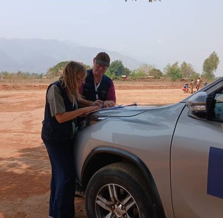 Duncan and his STO partner lean on a vehicle mapping their route for polling stations ahead of Election Day.