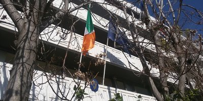 The exterior of the Irish Embassy building with the Irish and EU flags flying.