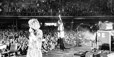 Black and white tour photo of Fontaines DC performing on stage