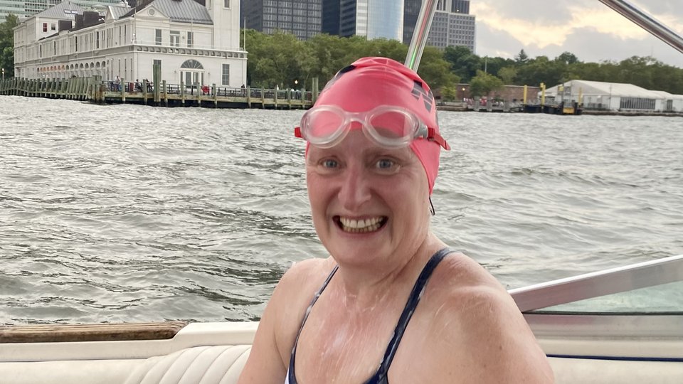 Woman sitting on a boat in swimming togs