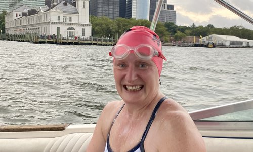 Woman sitting on a boat in swimming togs