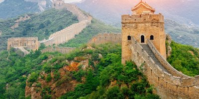 View of Beijing's skyline from the water at sunset.