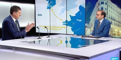 two men sitting side on talking, with interactive map of france and ireland connecting the two countries