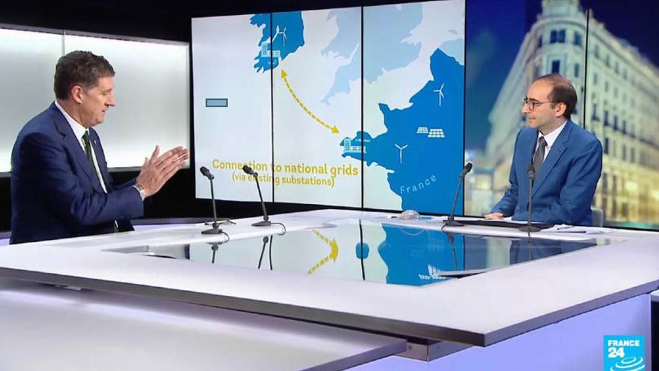 two men sitting side on talking, with interactive map of france and ireland connecting the two countries
