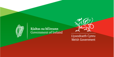 Green, red and white background with Government of Ireland and Government of Wales logos