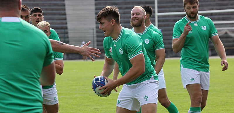 irish rugby team players practicing throwing a ball