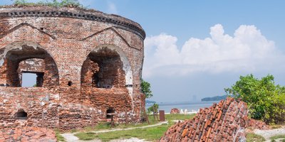 ruin of round redbrick building with arches - a martello tower