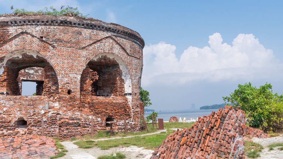 ruins of a round red brick building with arches