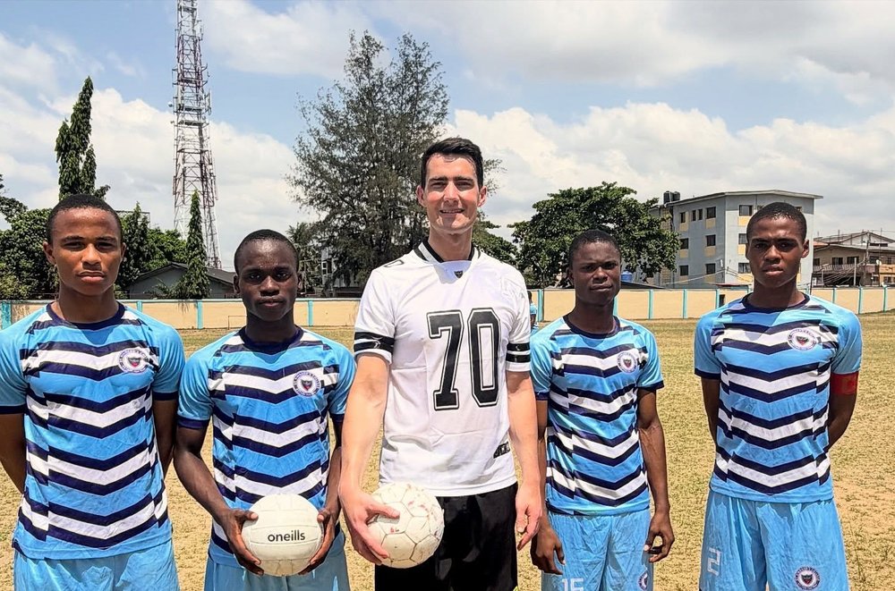A group picture of men in sportswear on a field