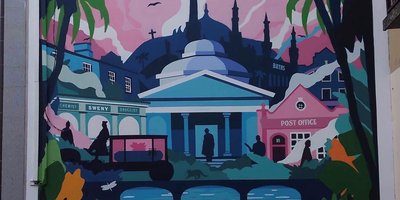 colourful mural painted on the side of a building with dome lie rooves
