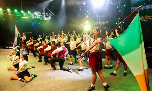 Celtic Argentina dance group on a stage with Irish flag