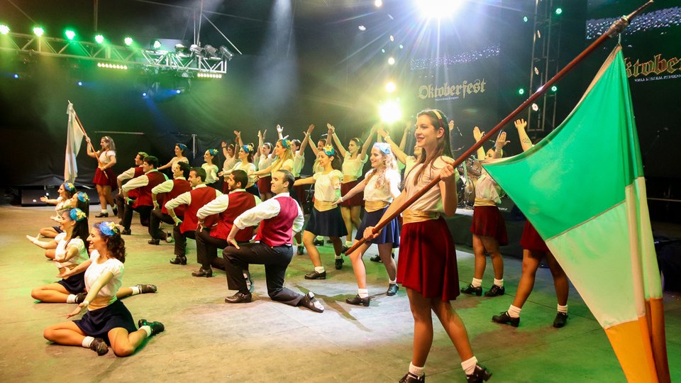Celtic Argentina dance group on a stage with Irish flag