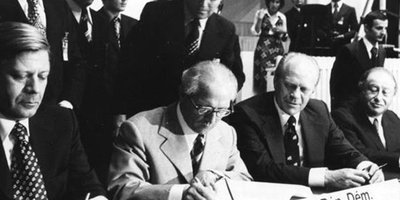 A black and white photo of the initial signatures from the founding of the OSCE.