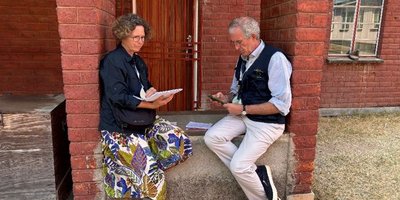 Paul and his LTO partner on Election Day recording and planning their day outside a red-brick building