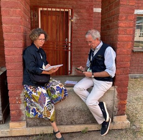 Paul and his LTO partner on Election Day recording and planning their day outside a red-brick building