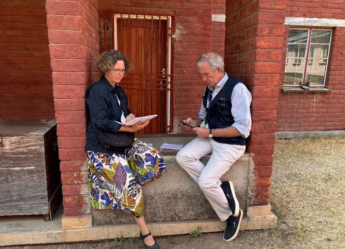 Paul and his LTO partner on Election Day recording and planning their day outside a red-brick window