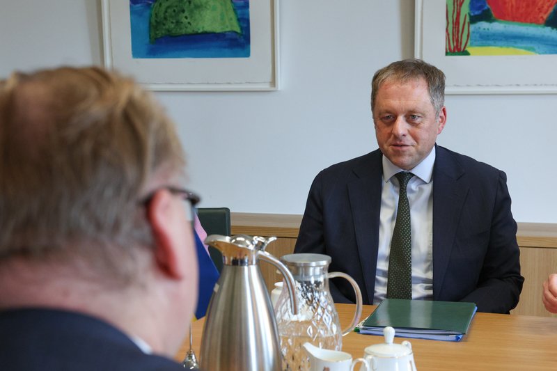 Minister Byrne sits at a meeting table opposite his Ukrainian counterpart. Two jugs are visible on the table.