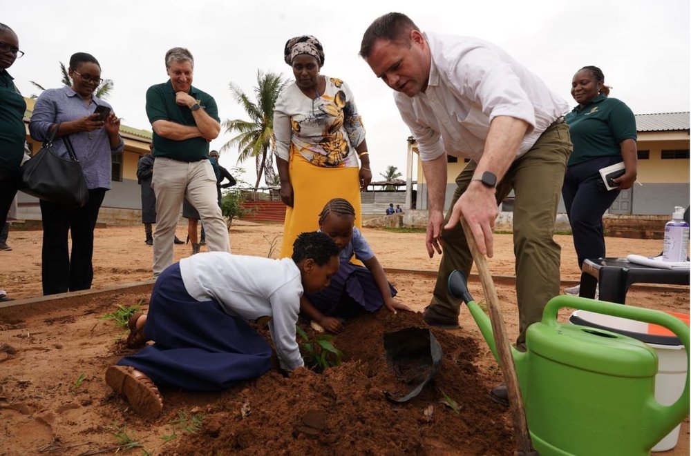 Neale Richmond working in a field with children