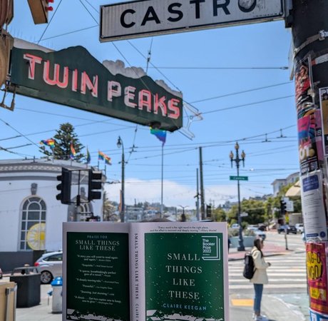 person holding the book Small things like these at a junction in san francisco