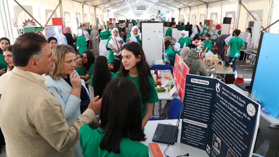 Students discussing their projects at a stand