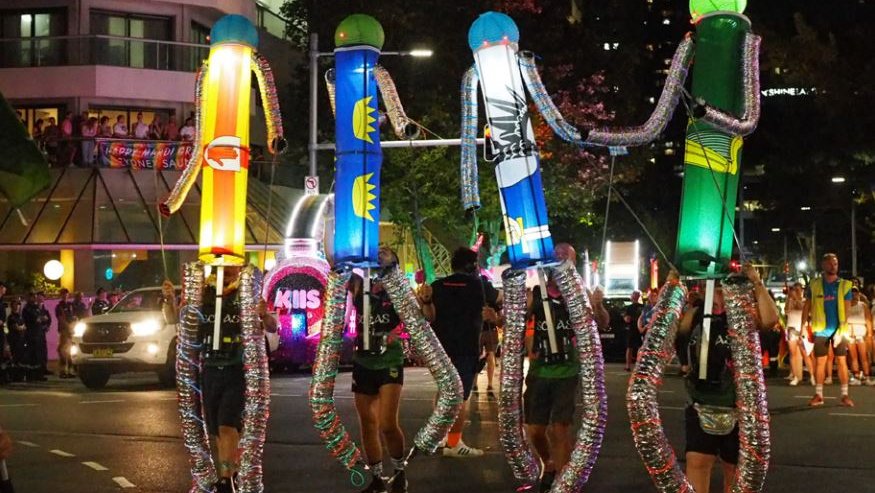 parade at night time carrying robot laterns with different colours